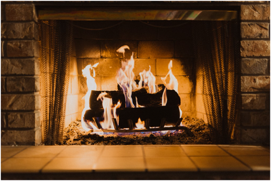 burning logs in brick fireplace.