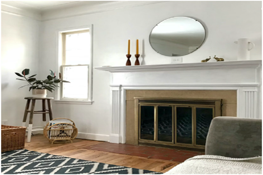 Statement mantel on top of a modern fireplace.